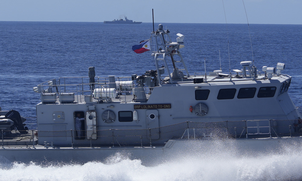 Philippine forces retake an island in mock combat as China's navy watches